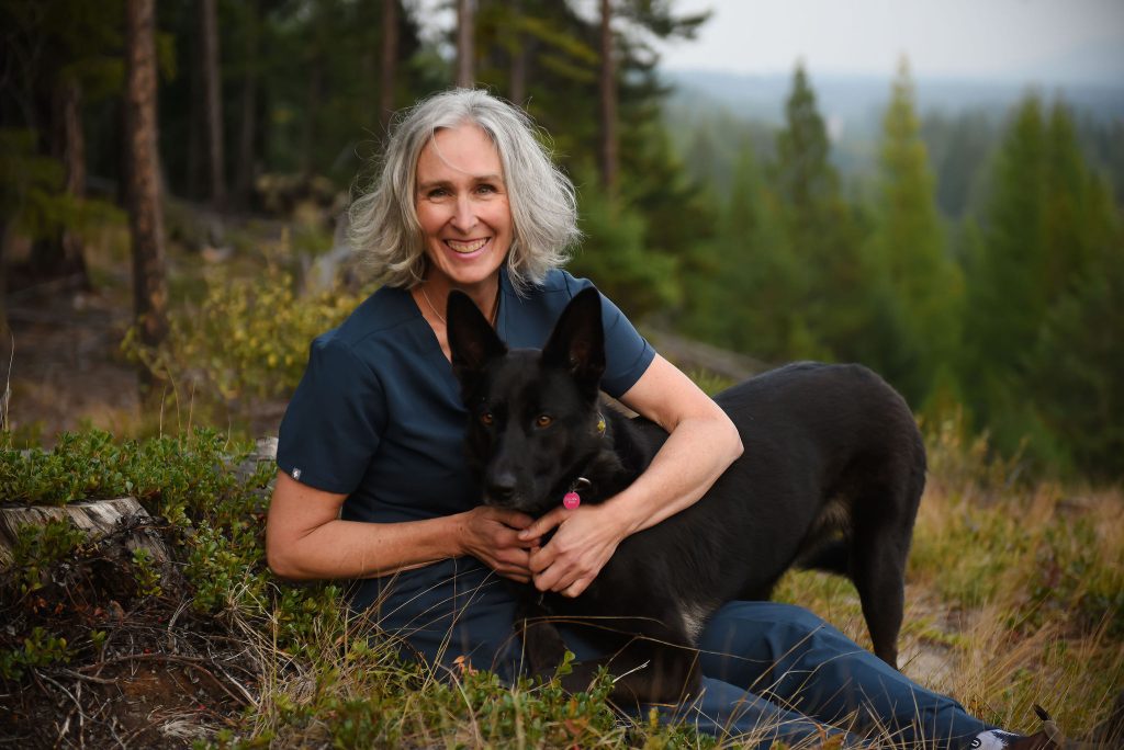 Portrait of Dr. Denise Lowing with her dog in the East Kootenay region