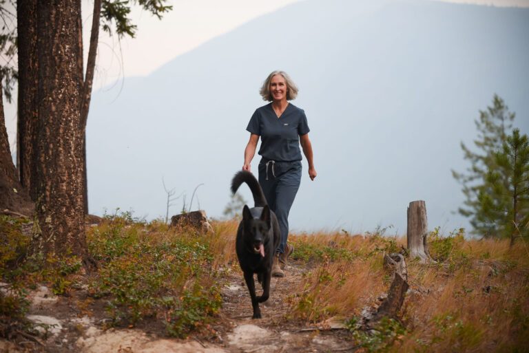 Dr. Lowing walking with her dog through the East Kootenay landscape